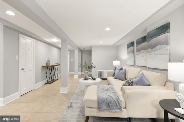 living room with light tile patterned floors, recessed lighting, baseboards, and radiator