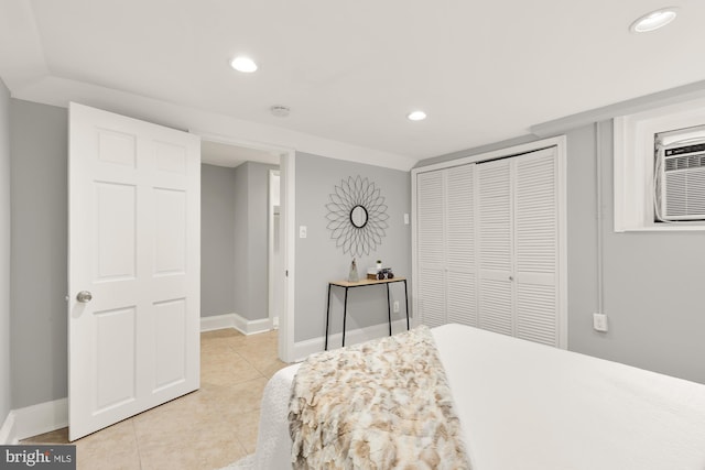 bedroom featuring recessed lighting, a closet, light tile patterned flooring, and baseboards