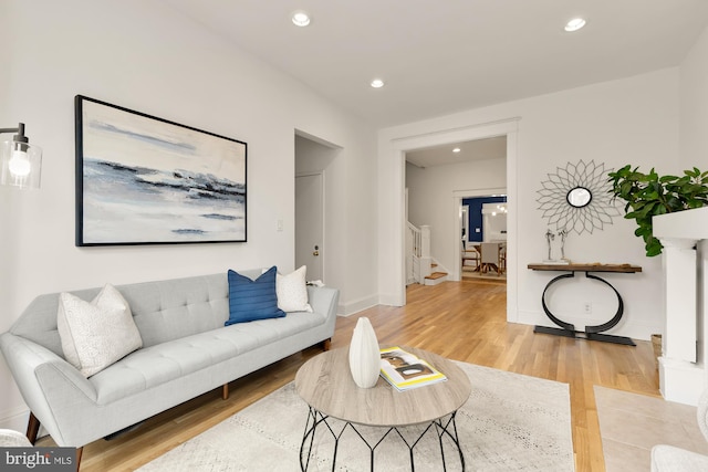 living room with baseboards, stairway, wood finished floors, and recessed lighting