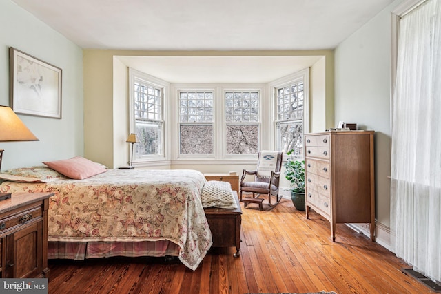 bedroom with light wood-type flooring and visible vents