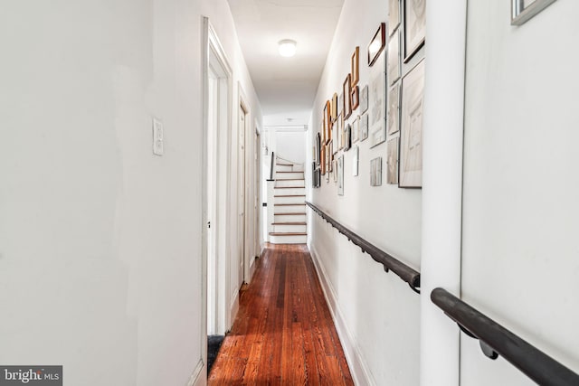 hallway featuring dark wood-style floors and stairway