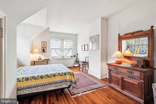 bedroom with baseboards and light wood finished floors