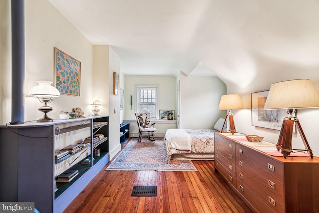 bedroom with dark wood-type flooring, visible vents, and baseboards