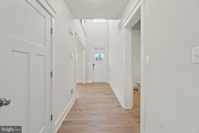 corridor with light hardwood / wood-style floors