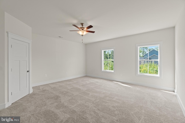 unfurnished room with light carpet and ceiling fan