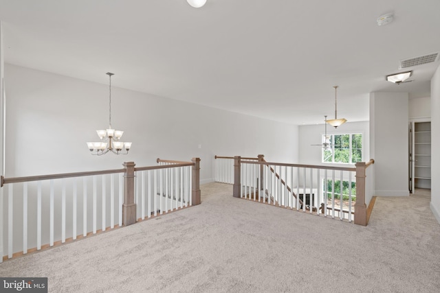 interior space with a notable chandelier and light carpet