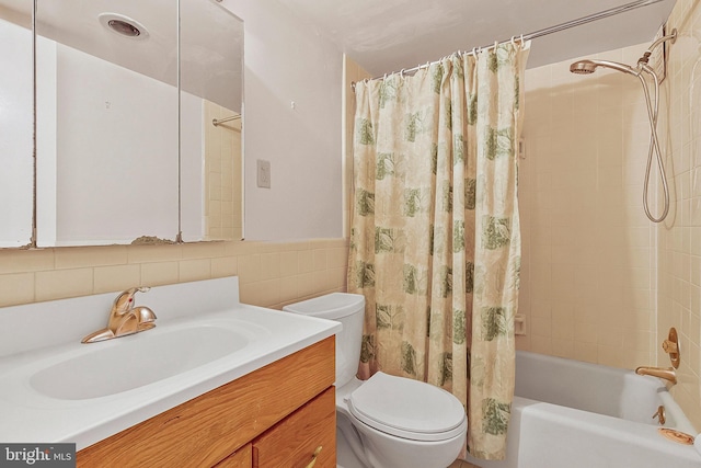 bathroom with toilet, shower / bath combo, vanity, and tile walls