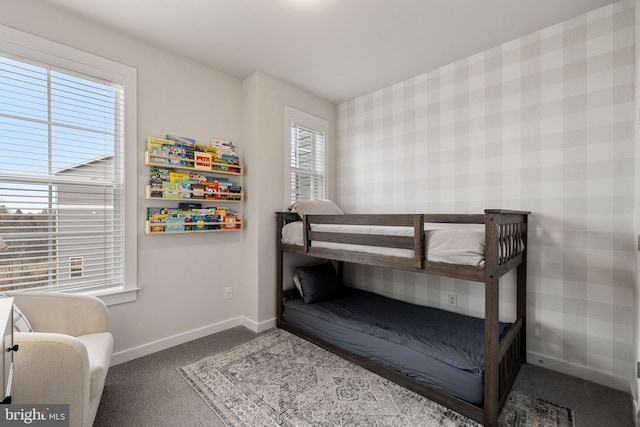 bedroom featuring baseboards, carpet, and wallpapered walls