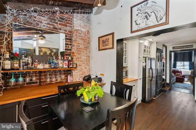 bar featuring wood counters, white cabinetry, dark wood-type flooring, and appliances with stainless steel finishes