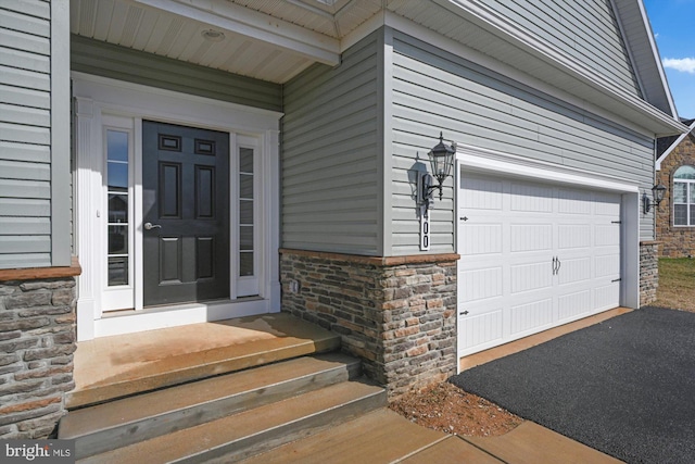 view of exterior entry featuring a garage