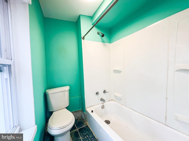 full bathroom featuring tile patterned flooring, bathing tub / shower combination, and toilet