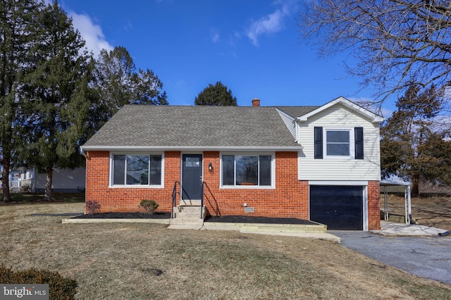 split level home featuring entry steps, brick siding, roof with shingles, and aphalt driveway