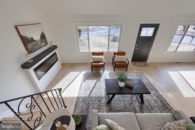 living room featuring baseboards and light wood finished floors