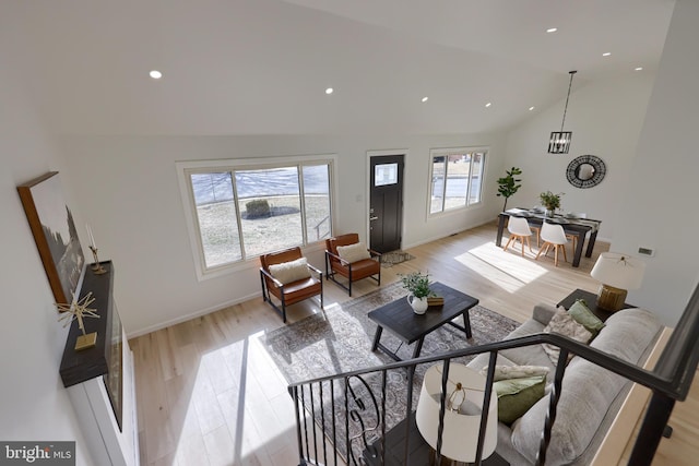 living room with light wood-style flooring, baseboards, and recessed lighting