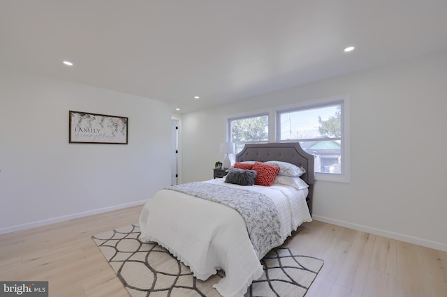 bedroom with recessed lighting, light wood-style flooring, and baseboards