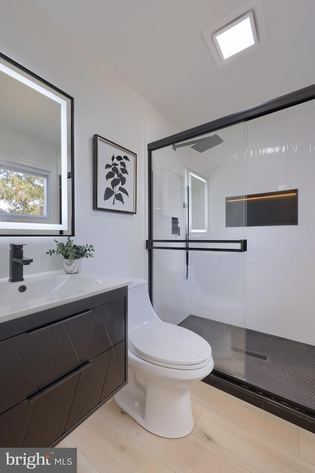 full bath featuring vanity, toilet, and a shower stall