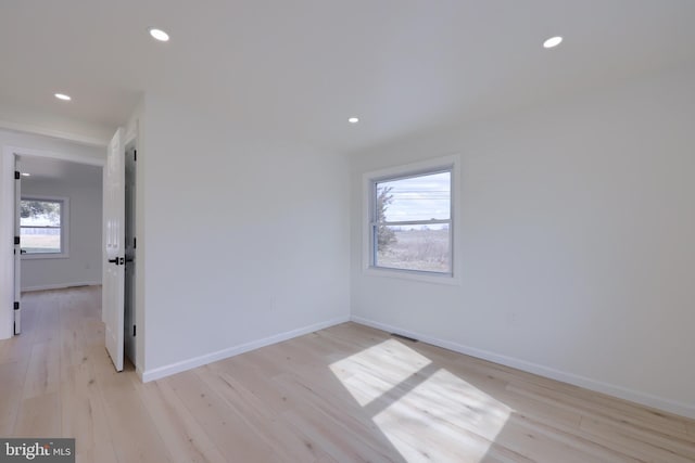 unfurnished room with recessed lighting, baseboards, and light wood finished floors