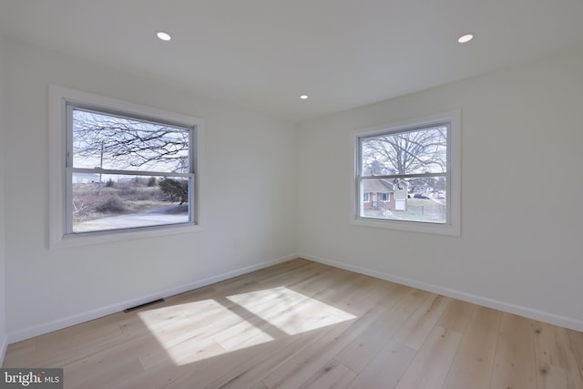 empty room with light wood-style flooring and baseboards