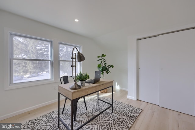 home office with recessed lighting, vaulted ceiling, light wood-style flooring, and baseboards