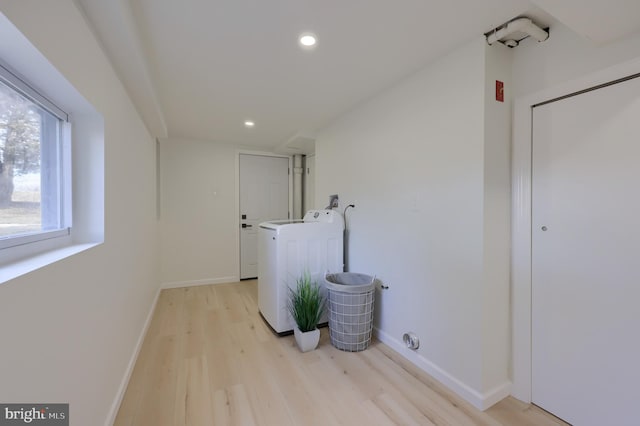 washroom with washer / dryer, recessed lighting, light wood-style flooring, and baseboards