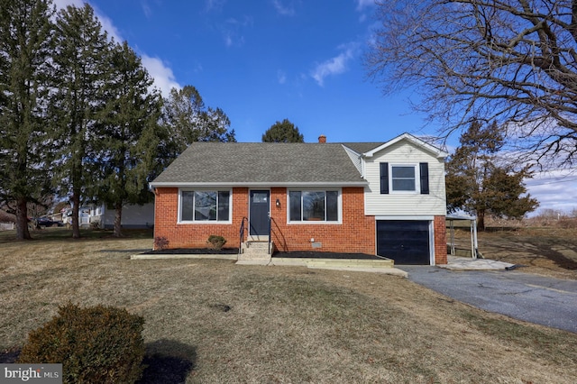 split level home featuring entry steps, aphalt driveway, a garage, brick siding, and roof with shingles