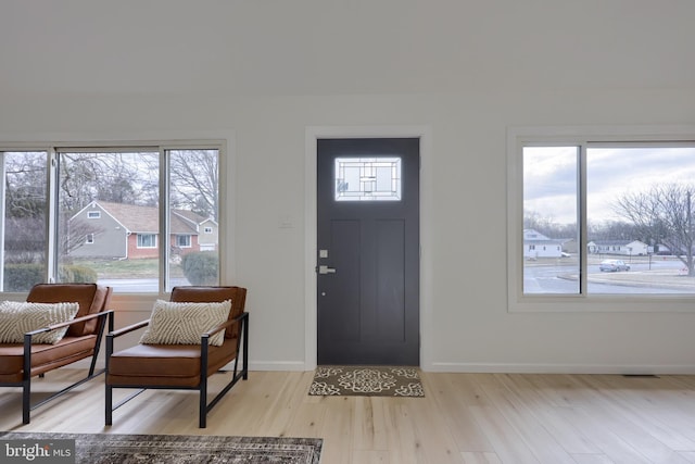 entrance foyer with light wood-style flooring and baseboards