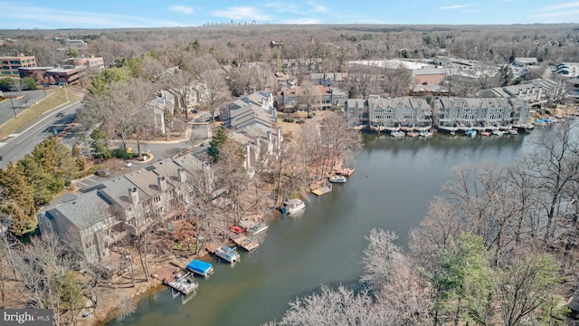 drone / aerial view with a water view and a residential view