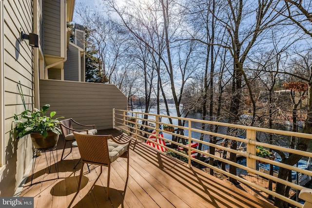 wooden deck featuring a water view