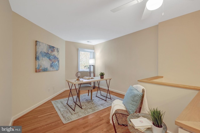 office space featuring ceiling fan, wood finished floors, and baseboards