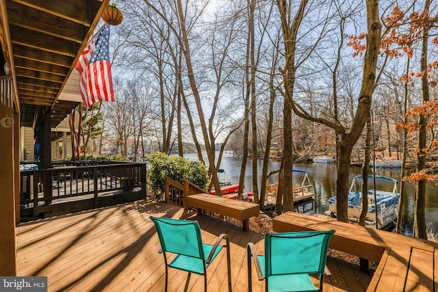 wooden terrace with a dock and a water view