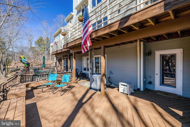 wooden deck featuring ac unit