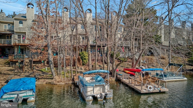 view of dock featuring stairs and a water view