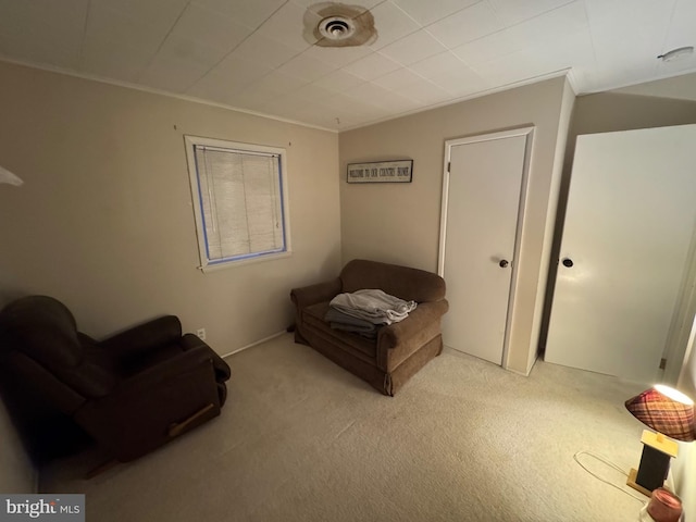 unfurnished room with ornamental molding and light colored carpet