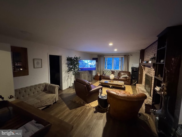 living room featuring hardwood / wood-style flooring and a fireplace