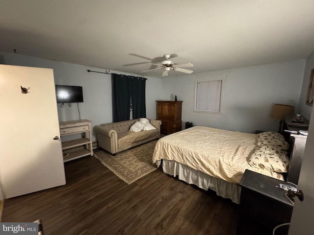 bedroom with dark wood-type flooring, ceiling fan, and white refrigerator