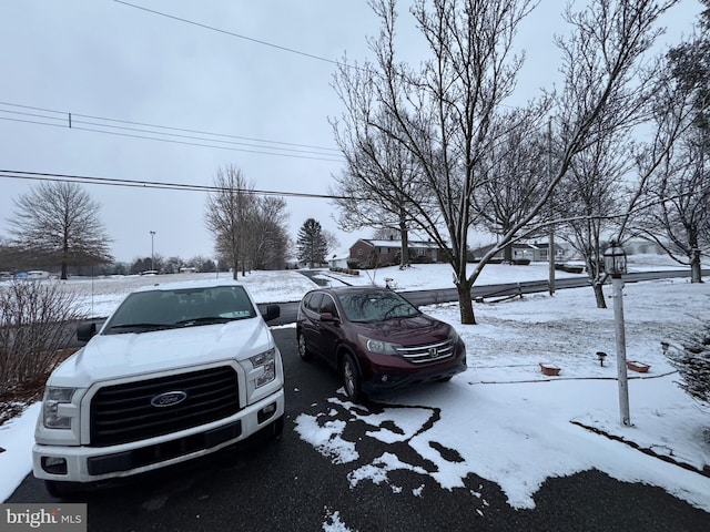 view of snow covered parking