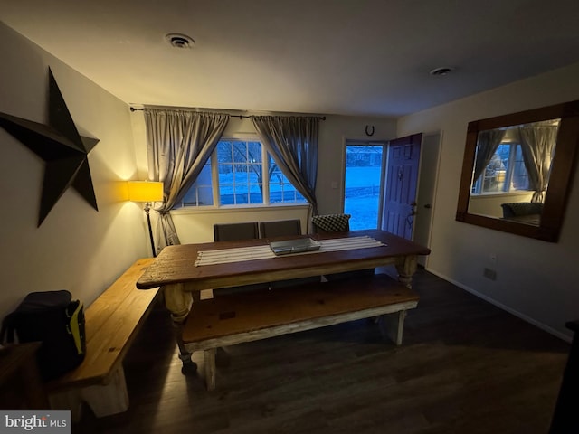 dining area featuring dark wood-type flooring