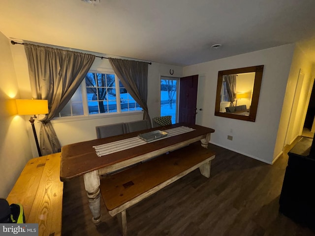 dining space with dark hardwood / wood-style flooring