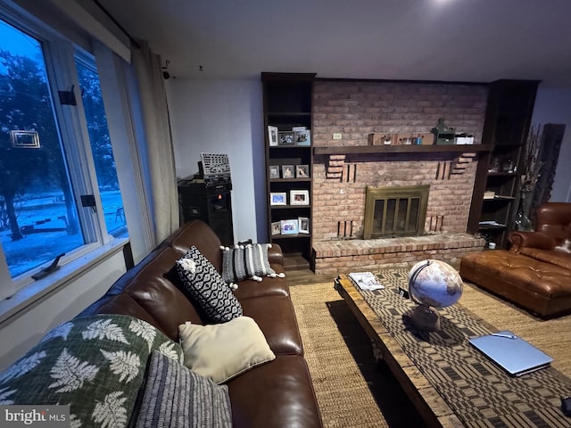 living room with a brick fireplace