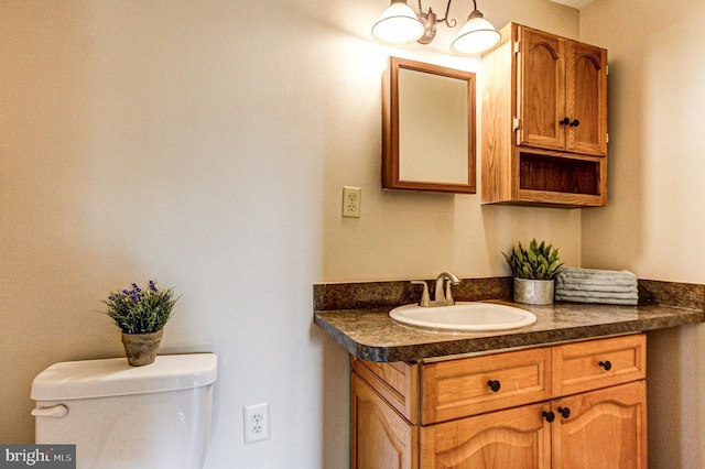 bathroom featuring toilet and vanity