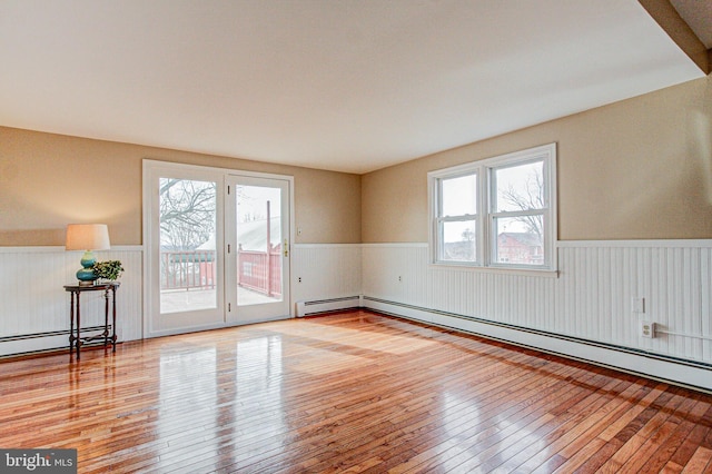 spare room featuring light hardwood / wood-style floors and a baseboard heating unit