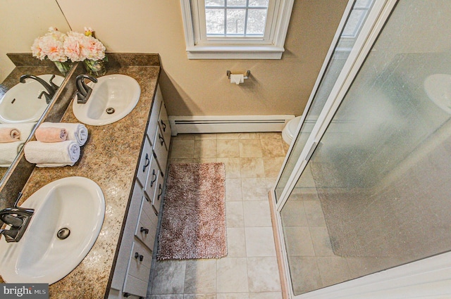 bathroom with toilet, a baseboard heating unit, an enclosed shower, and vanity