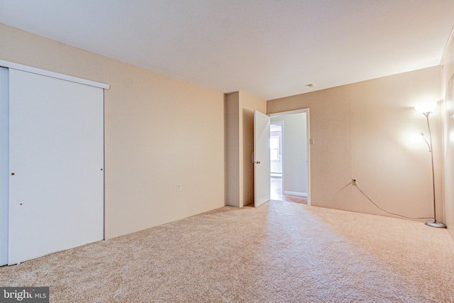 unfurnished bedroom featuring light carpet