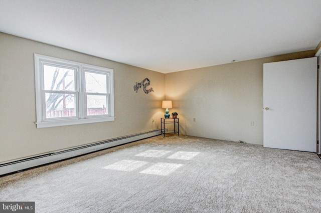 carpeted empty room with baseboard heating