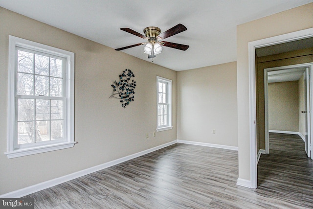 empty room with hardwood / wood-style flooring and ceiling fan