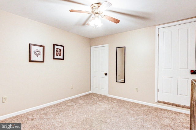 unfurnished bedroom with ceiling fan and light carpet