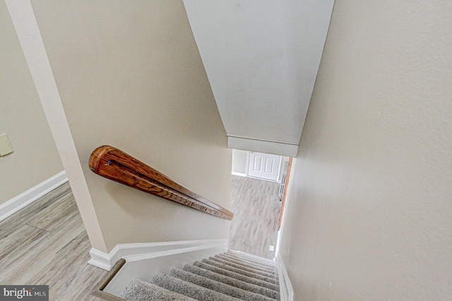 staircase with hardwood / wood-style flooring