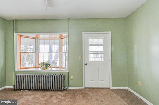 entryway with light carpet and radiator heating unit