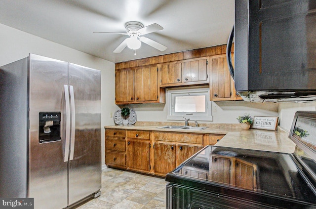 kitchen with ceiling fan, sink, electric stove, and stainless steel fridge