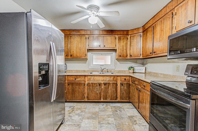 kitchen with appliances with stainless steel finishes, ceiling fan, and sink